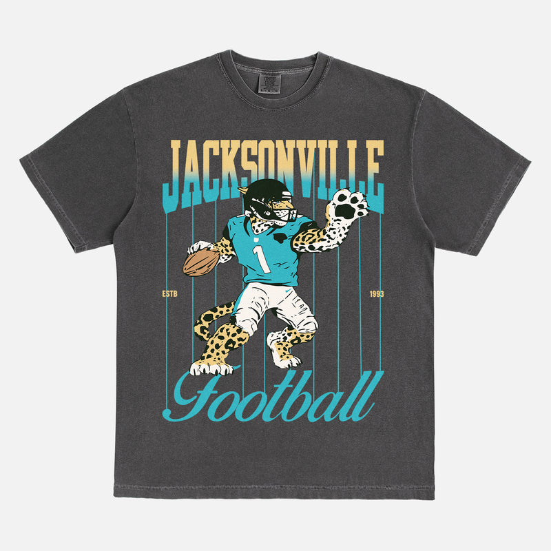Cool vintage Jacksonville Jaguars nfl football fan graphic t-shirt with retro mascot pinstripes gradient on a washed black comfort colors tee
