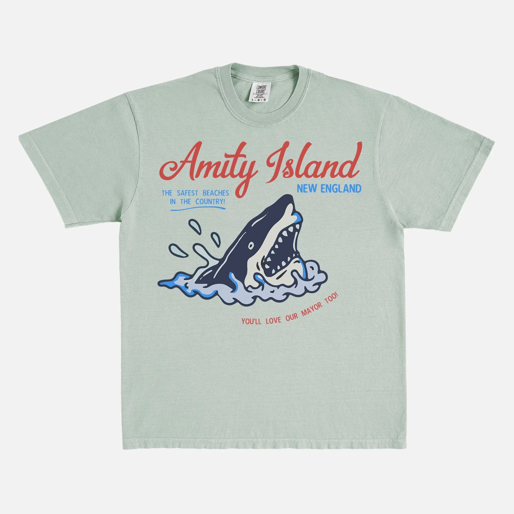 Funny Jaws Movie T-Shirt with retro  Amity Island travel poster logo on faded pale green Comfort Colors unisex t-shirt for sale at Throwbacks