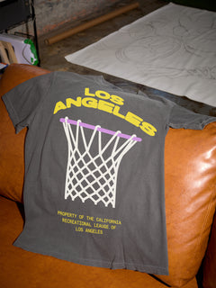 LA Lakers streetwear t-shirt with purple and gold oversized graphic on a distressed black shirt for sale at Throwbacks