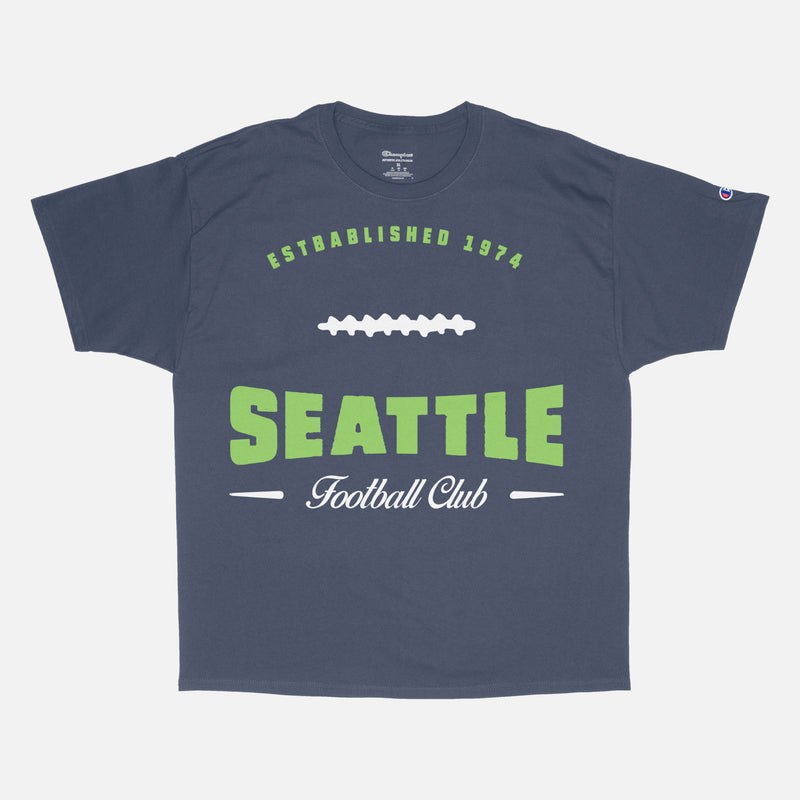 Head to your next Seattle seahawks football game with this vintage lime green graphic tee featuring a retro design printed on a premium unisex navy blue Champion t-shirt 