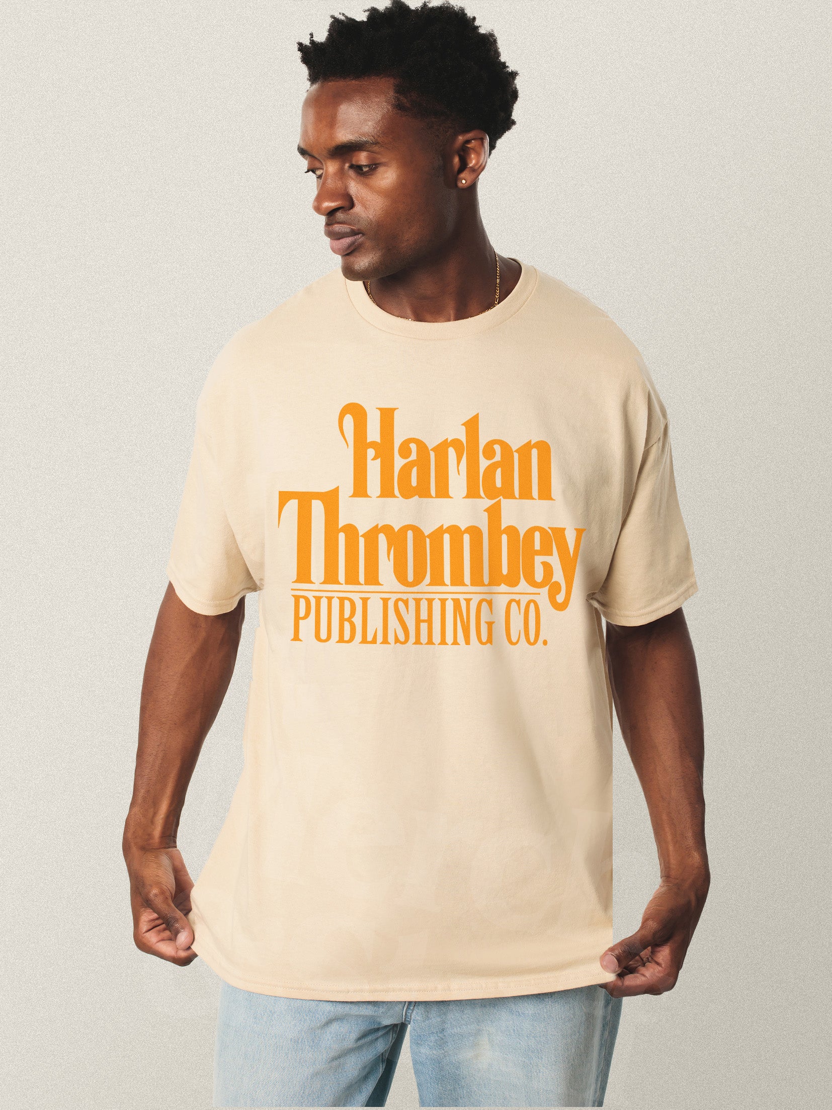 Knives out movie t-shirt, original Knives out movie graphic tee beige with large oversized yellow Harlan Thrombey Book Publishing Co logo on the front