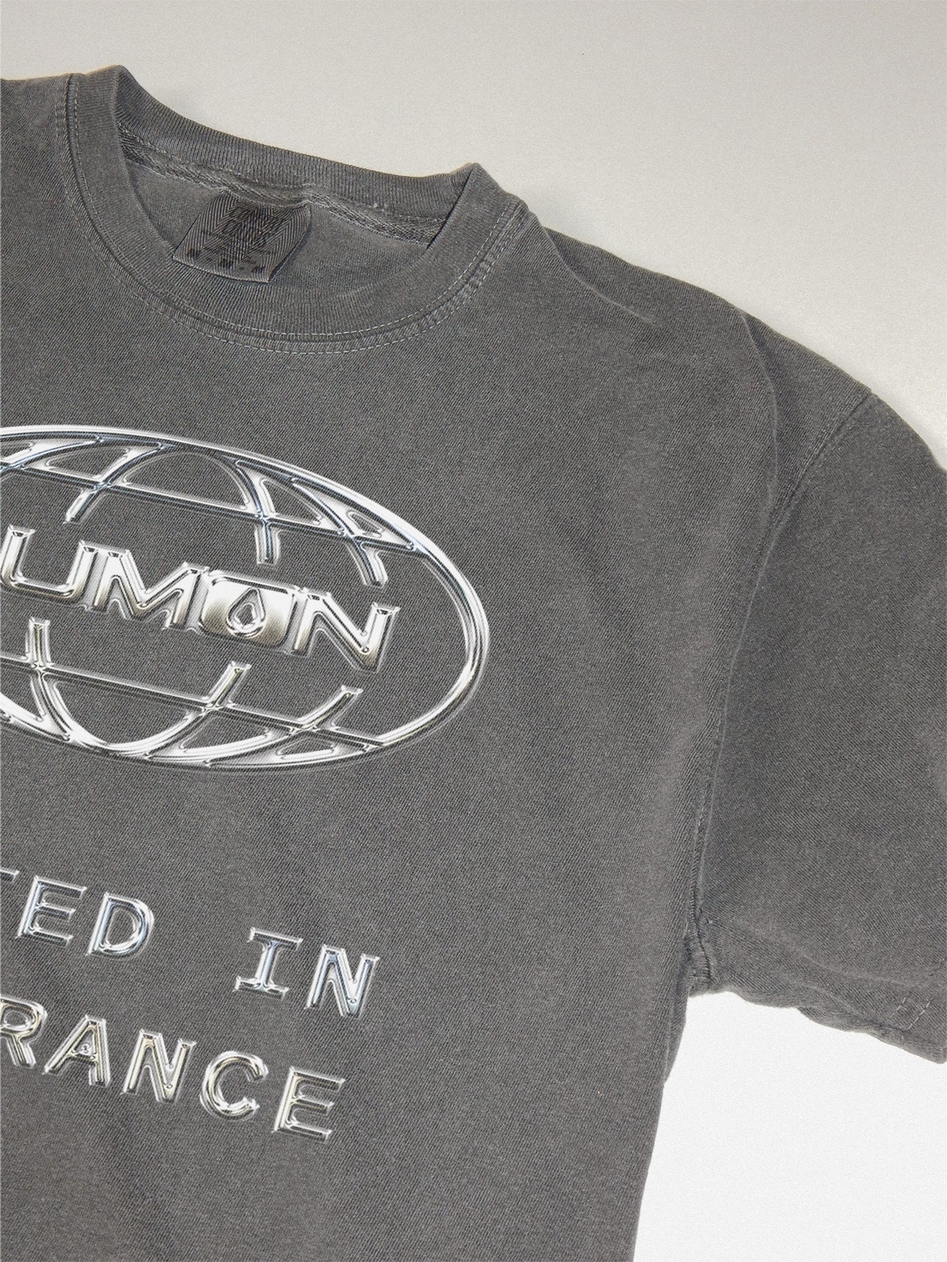 Macrodata Refinement Team at Lumon streetwear-style graphic tee featuring a custom chrome logo . Severance Apple TV Show t-shirt Printed on a faded black unsiex t-shirt 
