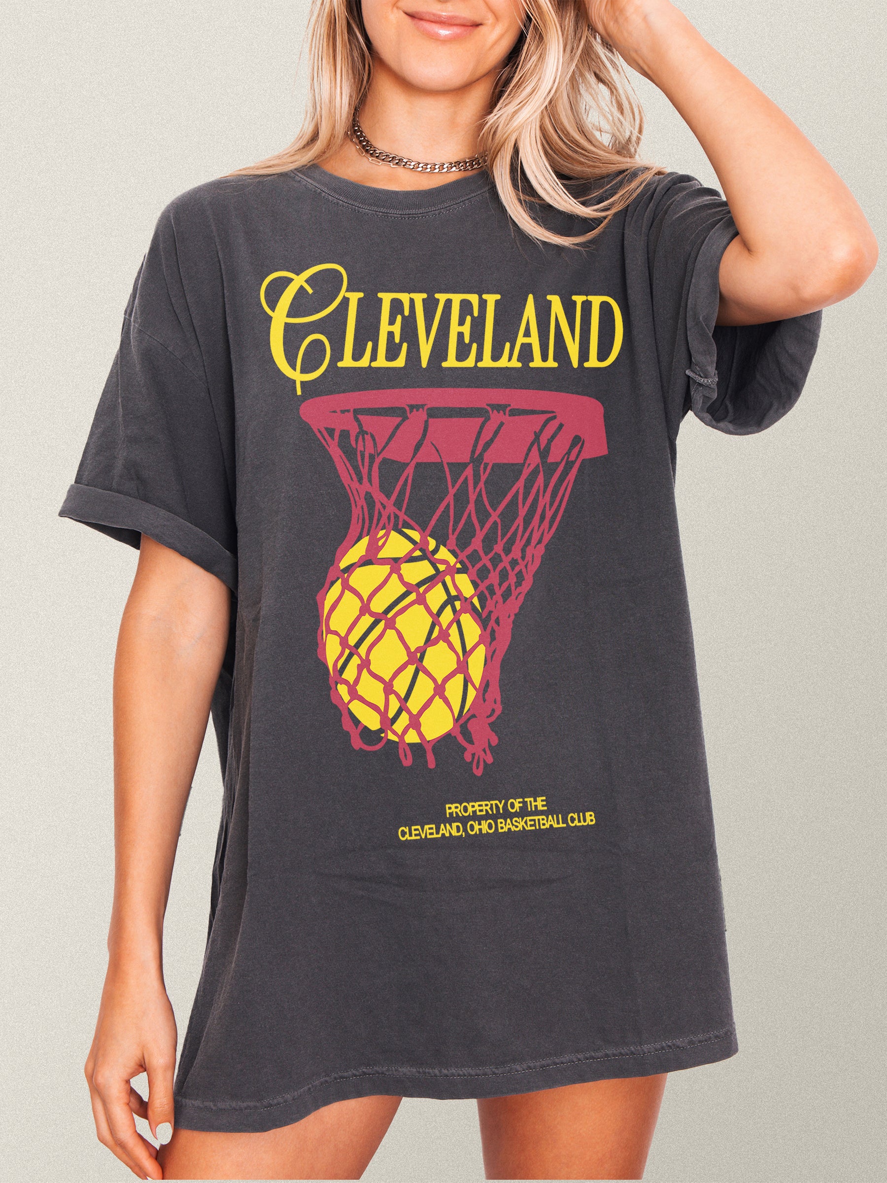 Washed black Cleveland Cavaliers basketball streetwear t-shirt with red and yellow jersey script text and basketball hoop on a unisex comfort colors graphic tee