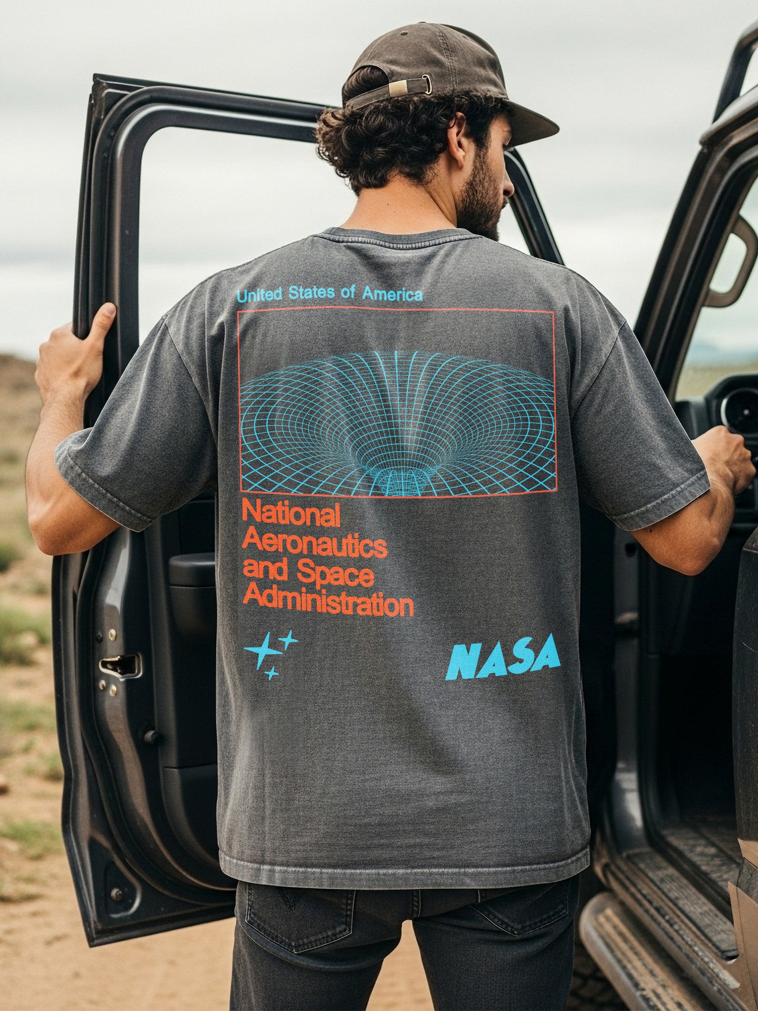 NASA logo graphic tee shirt with front and back print and oversized wormhole graphic and retro logo on a washed black Comfort Colors t-shirt