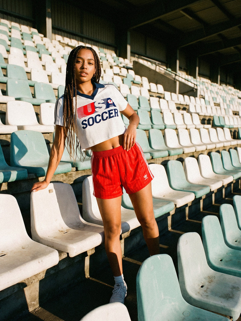 Cute vintage United States woman's soccer jersey, white with navy stripes and retro navy collor and USA soccer logo
