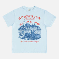 Funny Widow's Bay TV Show t-shirt with retro travel poster and sea hag on a light blue Comfort Colors graphic tee