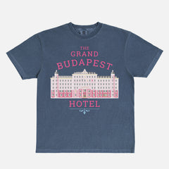 The Grand Budapest Hotel T-Shirt featuring an illustration of the iconic pink hotel façade in Wes Anderson-inspired colors on a soft unisex movie-lover graphic tee.