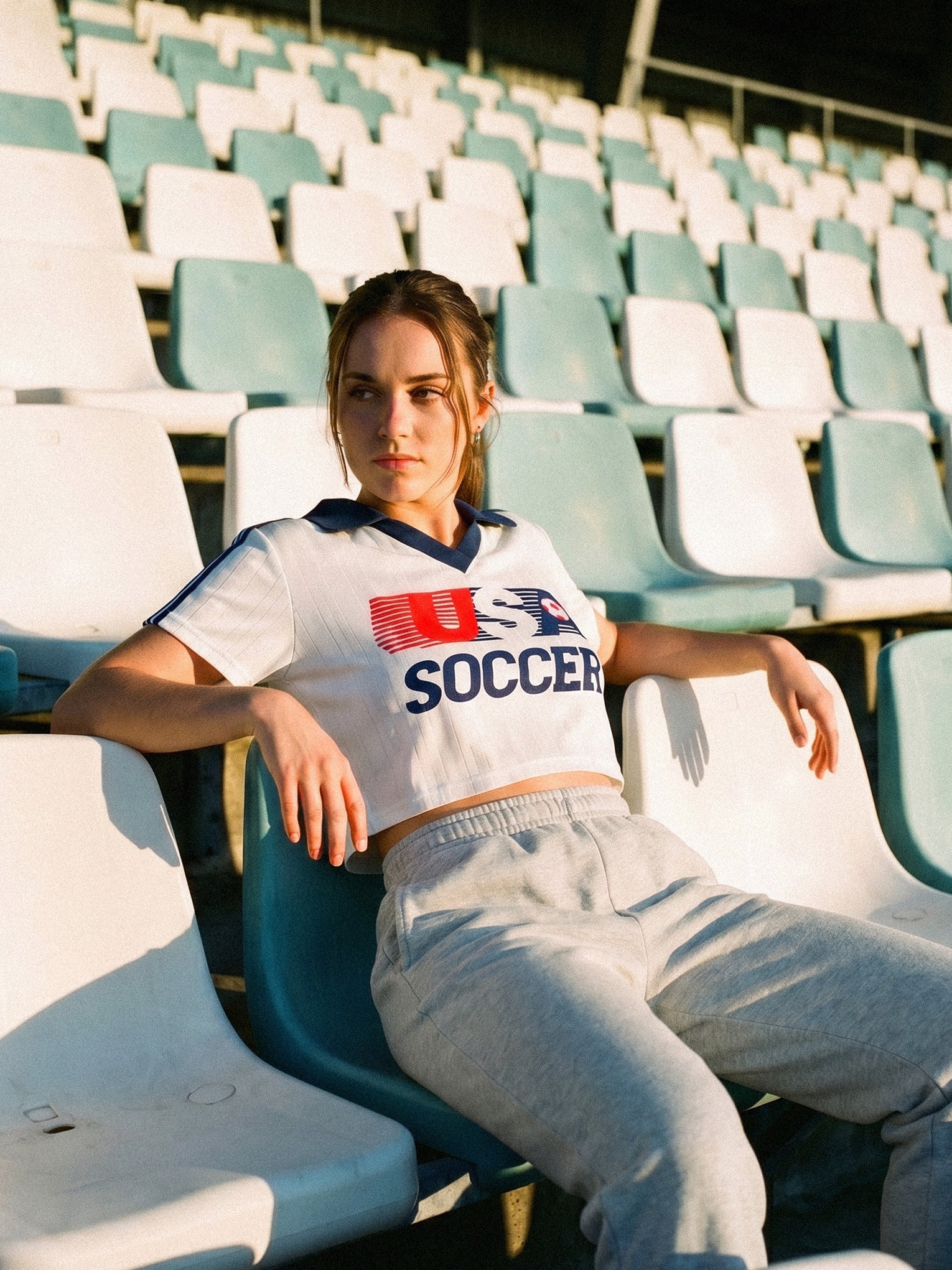 Cute vintage United States woman's soccer jersey, white with navy stripes and retro navy collor and USA soccer logo