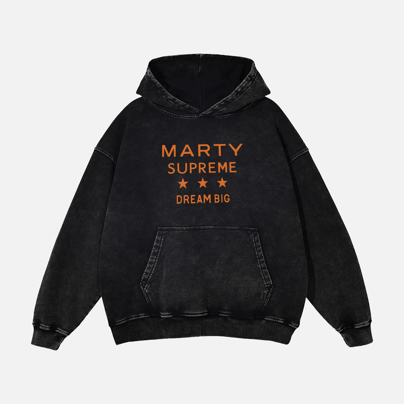 Marty Supreme hoodie distressed black heavyweight hooded sweatshirt with orange Marty Supreme Dream big text ont the front and ping pong head man in a jacket on the back