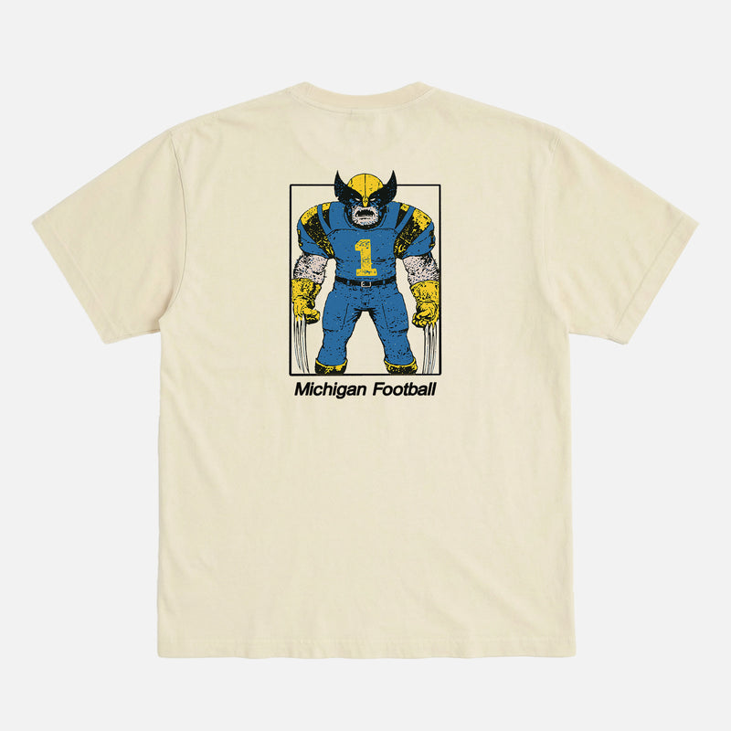 Michigan Wolverines college football t-shirt with Wolverine from X-Men as mascot football player on an off white comfort colors graphic tee
