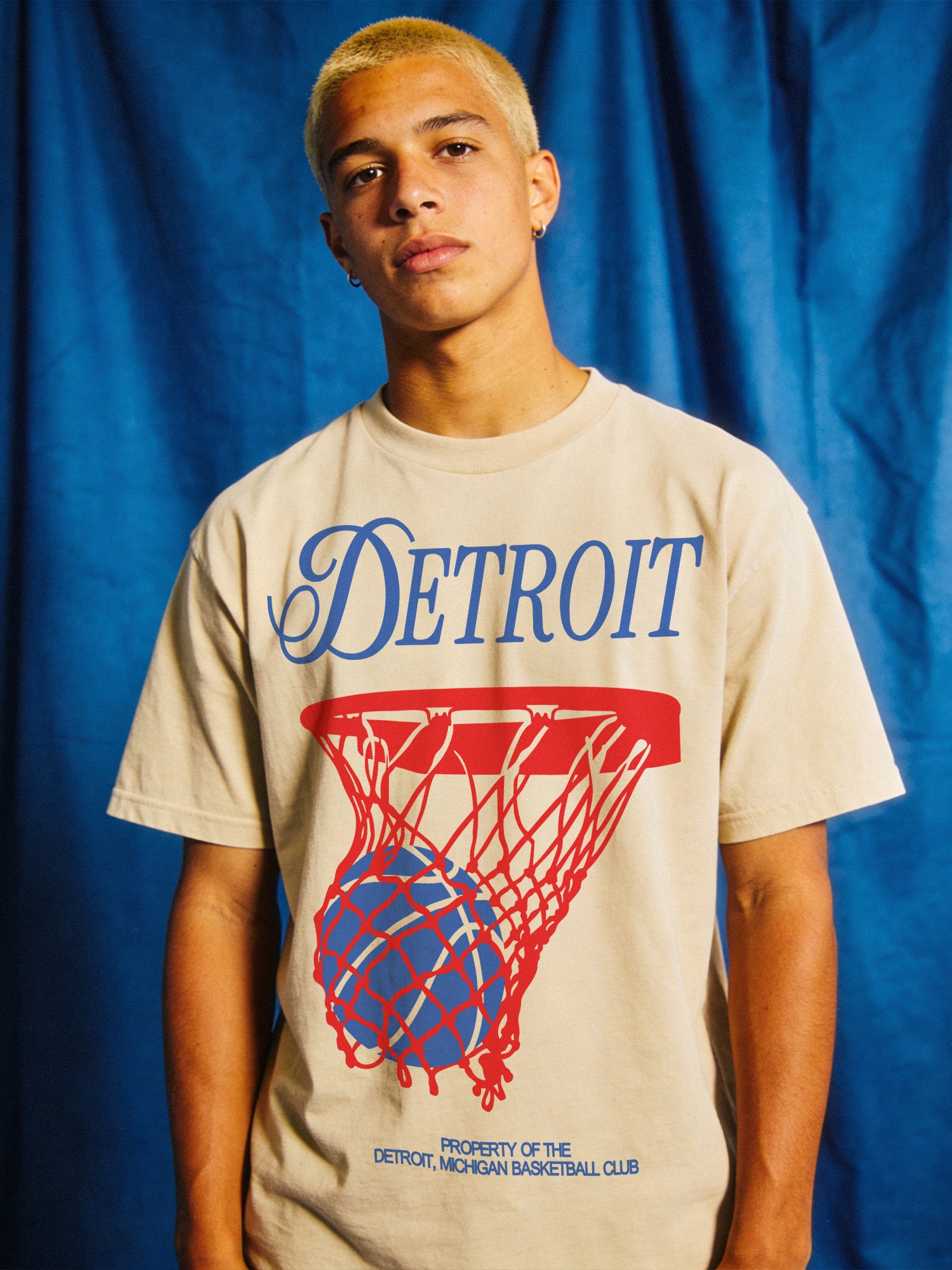 Retro Detroit Pistons basketball streetwear t-shirt with red and blue jersey script lettering on a unisex off white comfort colors graphic tee