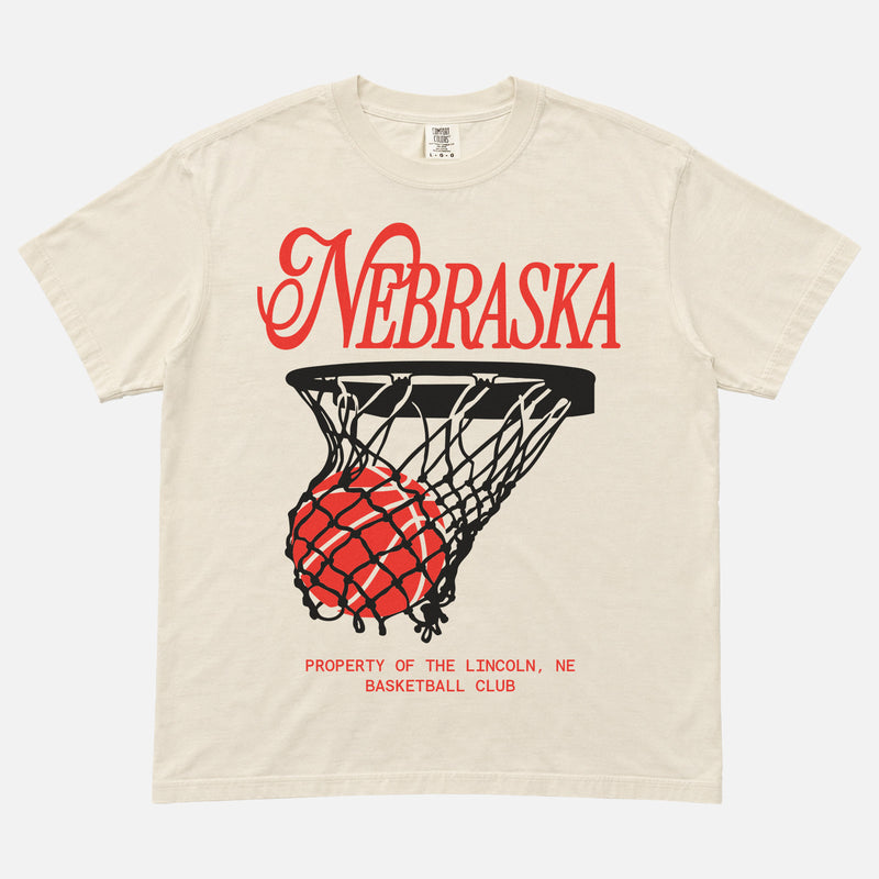 Retro Nebraska Cornhuskers t-shirt with retro college basketball streetwear graphic on an off white comfort colors tee