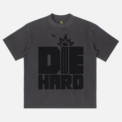 Faded black Die Hard movie shirt with retro movie poster text and nakatomi plaza
