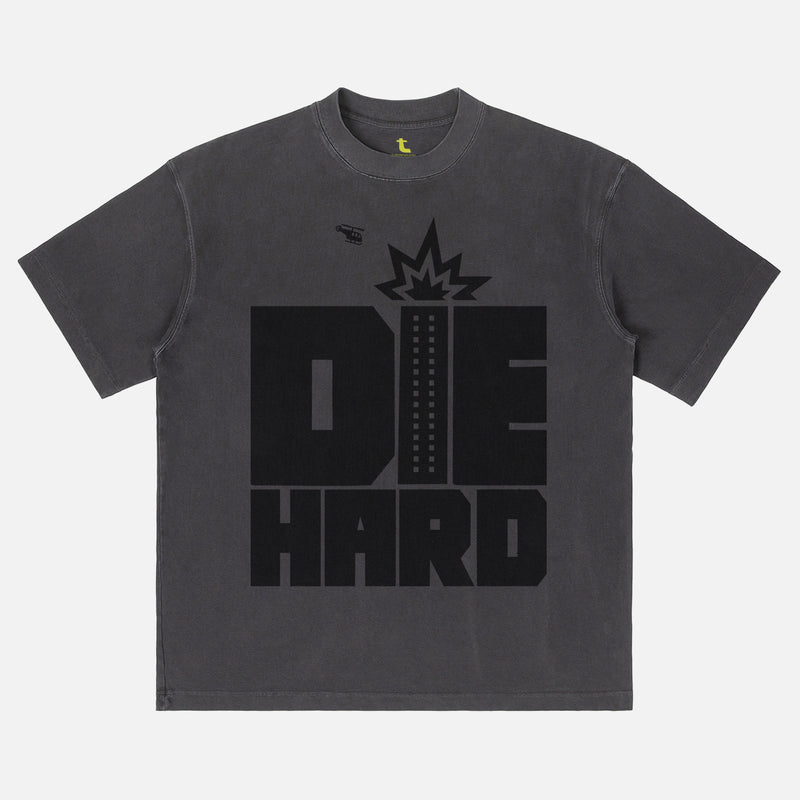Faded black Die Hard movie shirt with retro movie poster text and nakatomi plaza