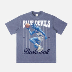 Washed blue retro Duke Blue Devils college basketball T‑shirt with vintage blue devil mascot graphic and pinstripes. 