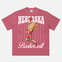 Vintage Nebraska Cornhuskers College Basketball Graphic T‑shirt with retro corn-on-the-cob mascot and pinstripes on an washed red bball tee for men and women