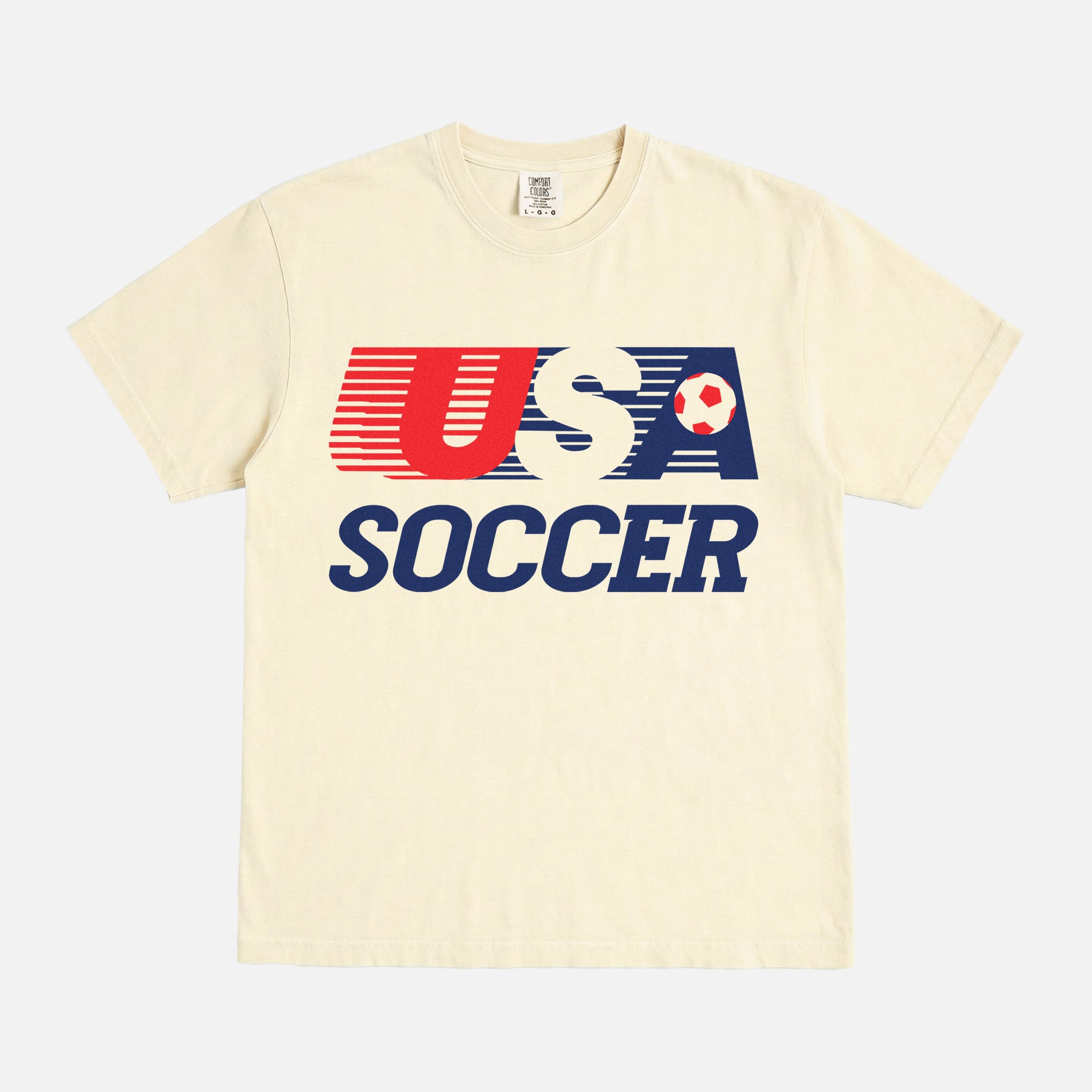 Retro USMNT USWNT United States Soccer logo t-shirt with striped USA soccer graphic on a washed cream unisex comfort colors tee