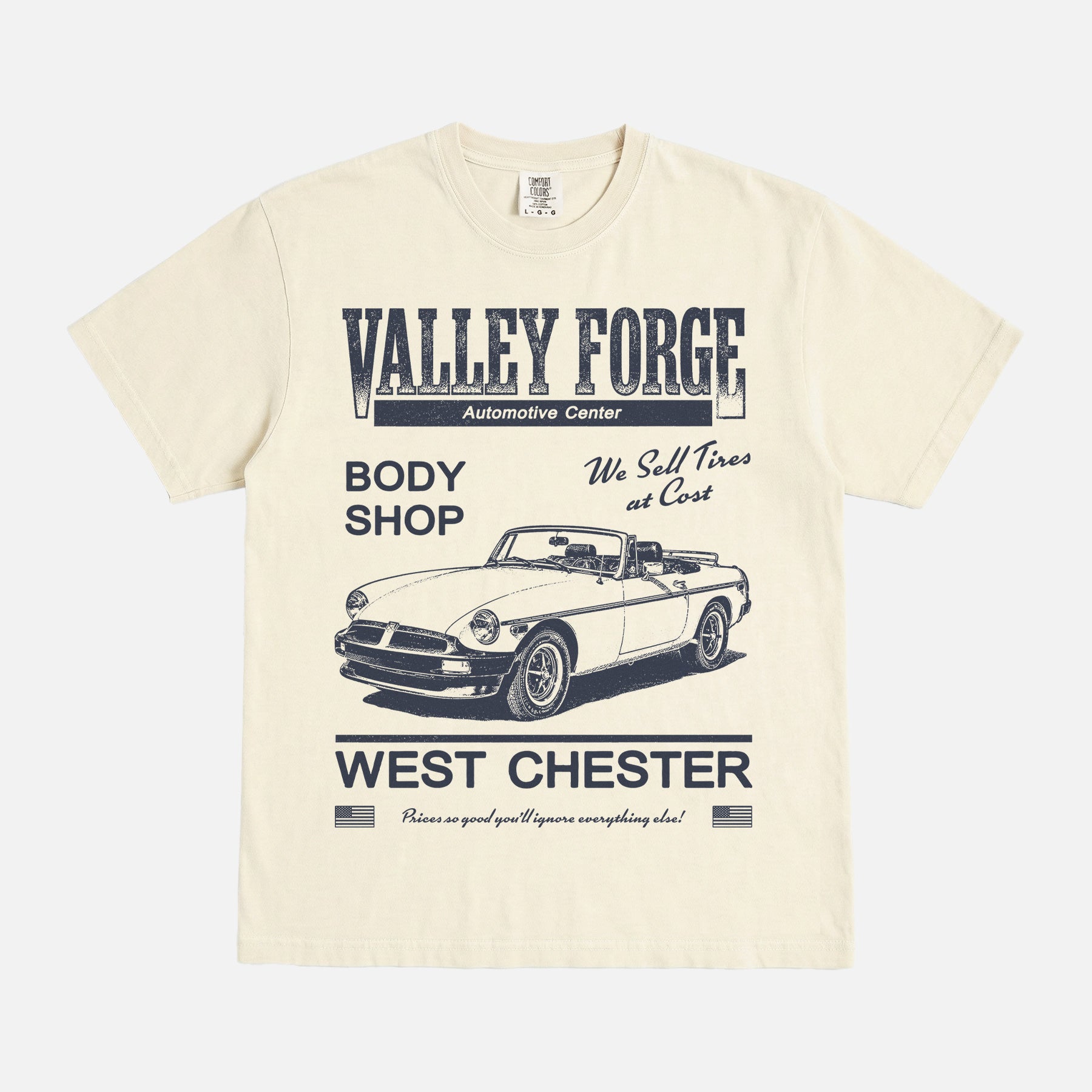 Funny Shane Gilles Tires TV Show graphic t-shirt with vintage Valley Forge Automotive center logo on a unisex beige and yellow comfort colors shirt
