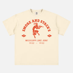 Ryan Coogler Sinners Movie t-shirt with orange Smoke and Stack's juke joint logo on an off white unisex graphic tee