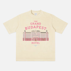 The Grand Budapest Hotel T-Shirt featuring an illustration of the iconic pink hotel façade in Wes Anderson-inspired colors on a soft unisex movie-lover graphic tee.