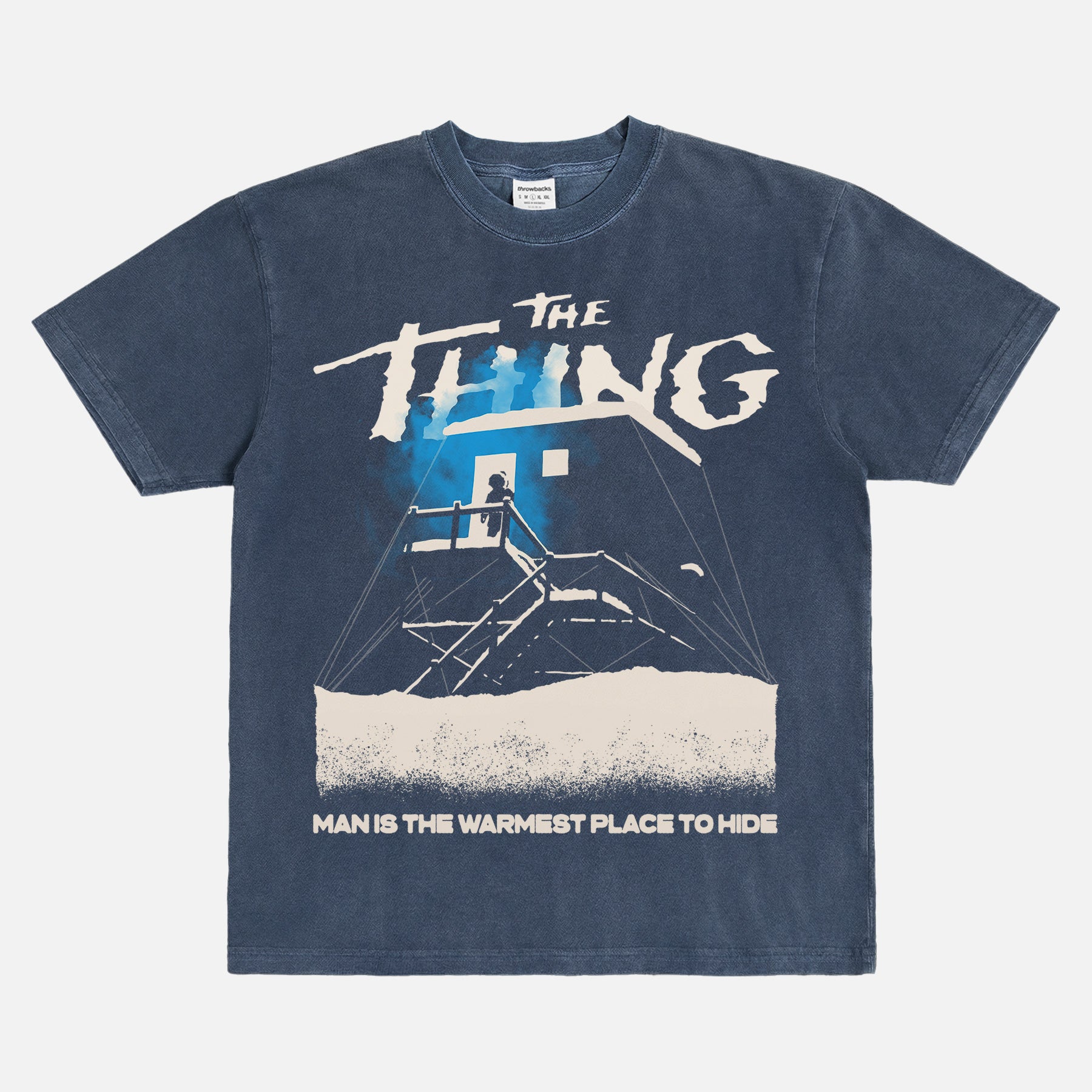 John Carpenter's The Thing 1982 graphic t-shirt with cabin snow art on a heavyweight navy graphic tee