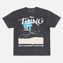John Carpenter's The Thing 1982 graphic t-shirt with cabin snow art on a heavyweight black graphic tee