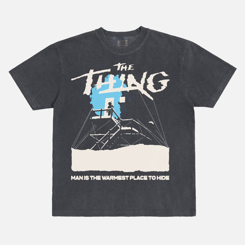 John Carpenter's The Thing 1982 graphic t-shirt with cabin snow art on a heavyweight black graphic tee