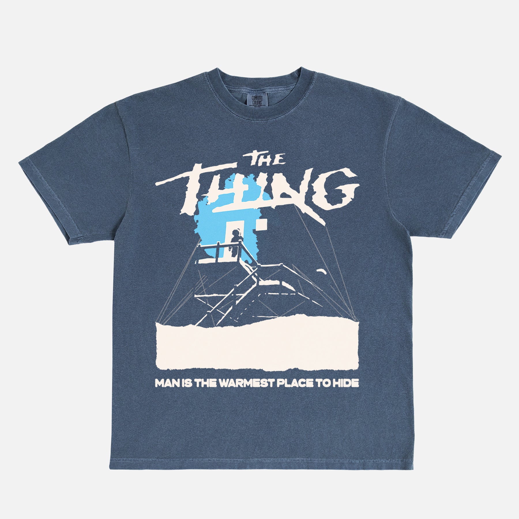 John Carpenter's The Thing 1982 graphic t-shirt with cabin snow art on a heavyweight navy graphic tee