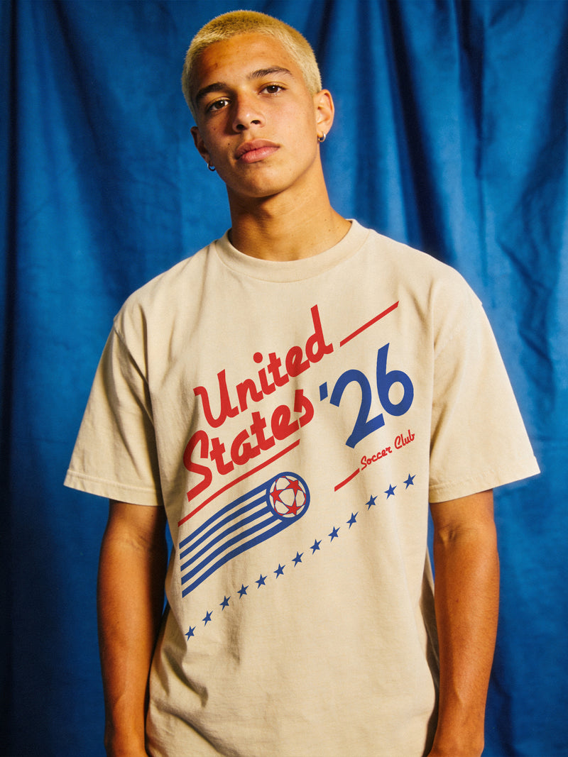 Cool retro 1980s US Soccer team graphic t-shirt with vintage royal blue and red 90s style Untied States USA soccer graphic on an off white Comfort Colors t-shirt