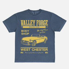 Funny Shane Gilles Tires TV Show graphic t-shirt with vintage Valley Forge Automotive center logo on a unisex navy and yellow comfort colors shirt