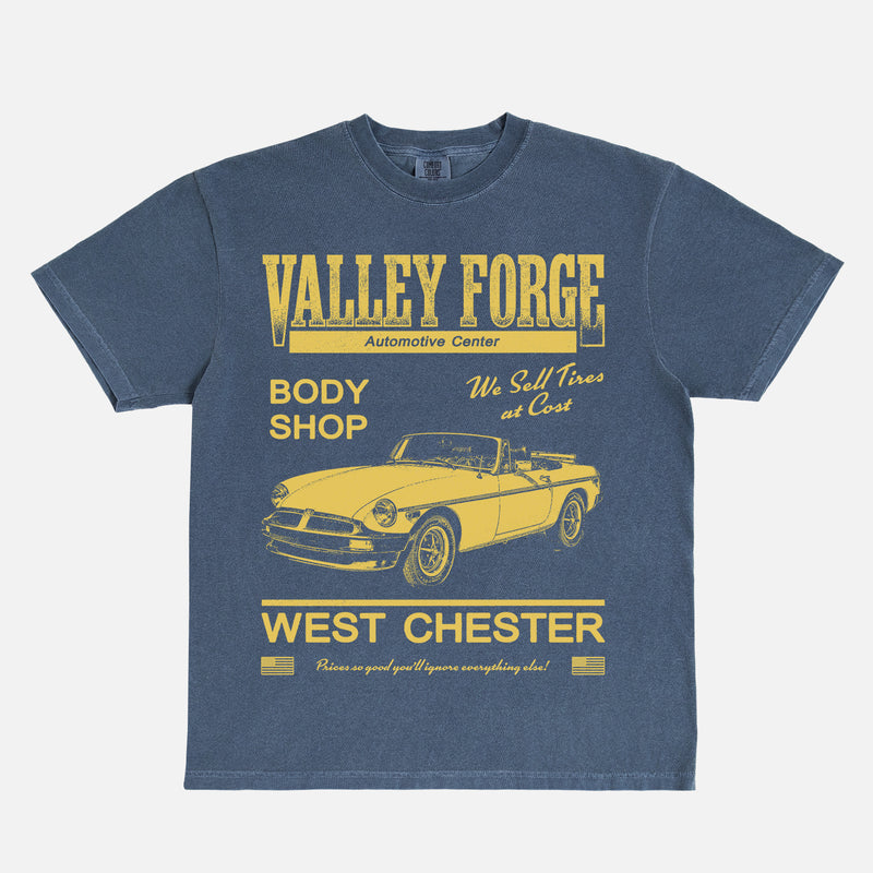 Funny Shane Gilles Tires TV Show graphic t-shirt with vintage Valley Forge Automotive center logo on a unisex navy and yellow comfort colors shirt