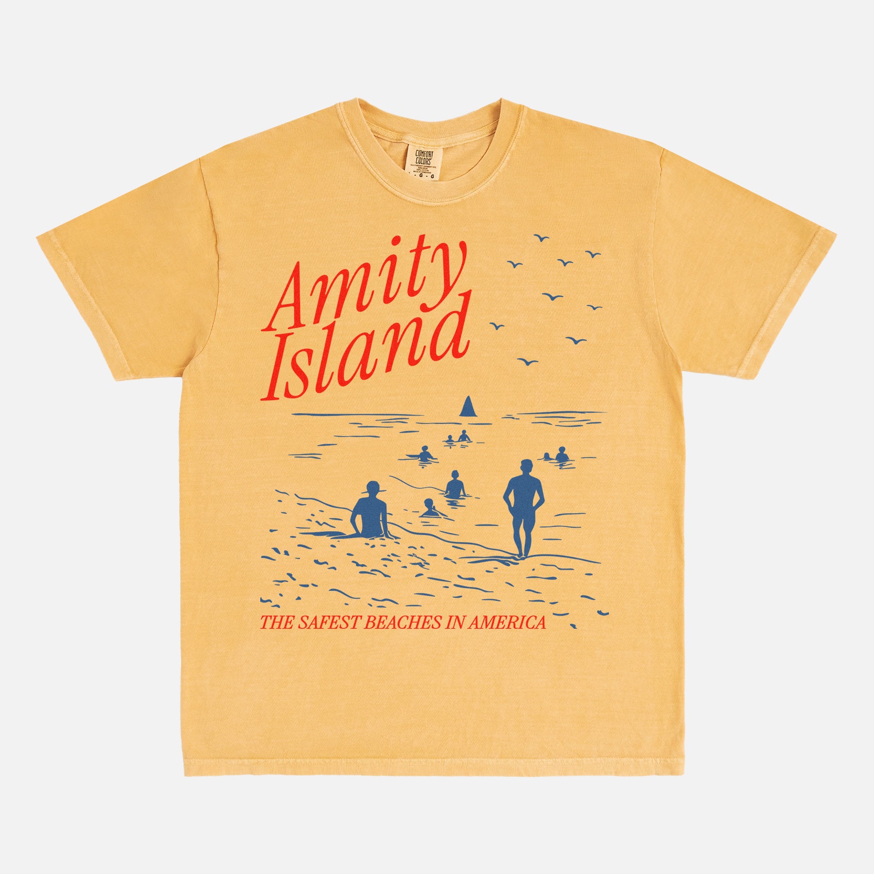 Washed yellow amity island jaws movie t-shirt with funny beach travel poster graphic on a unisex comfort colors graphic tee
