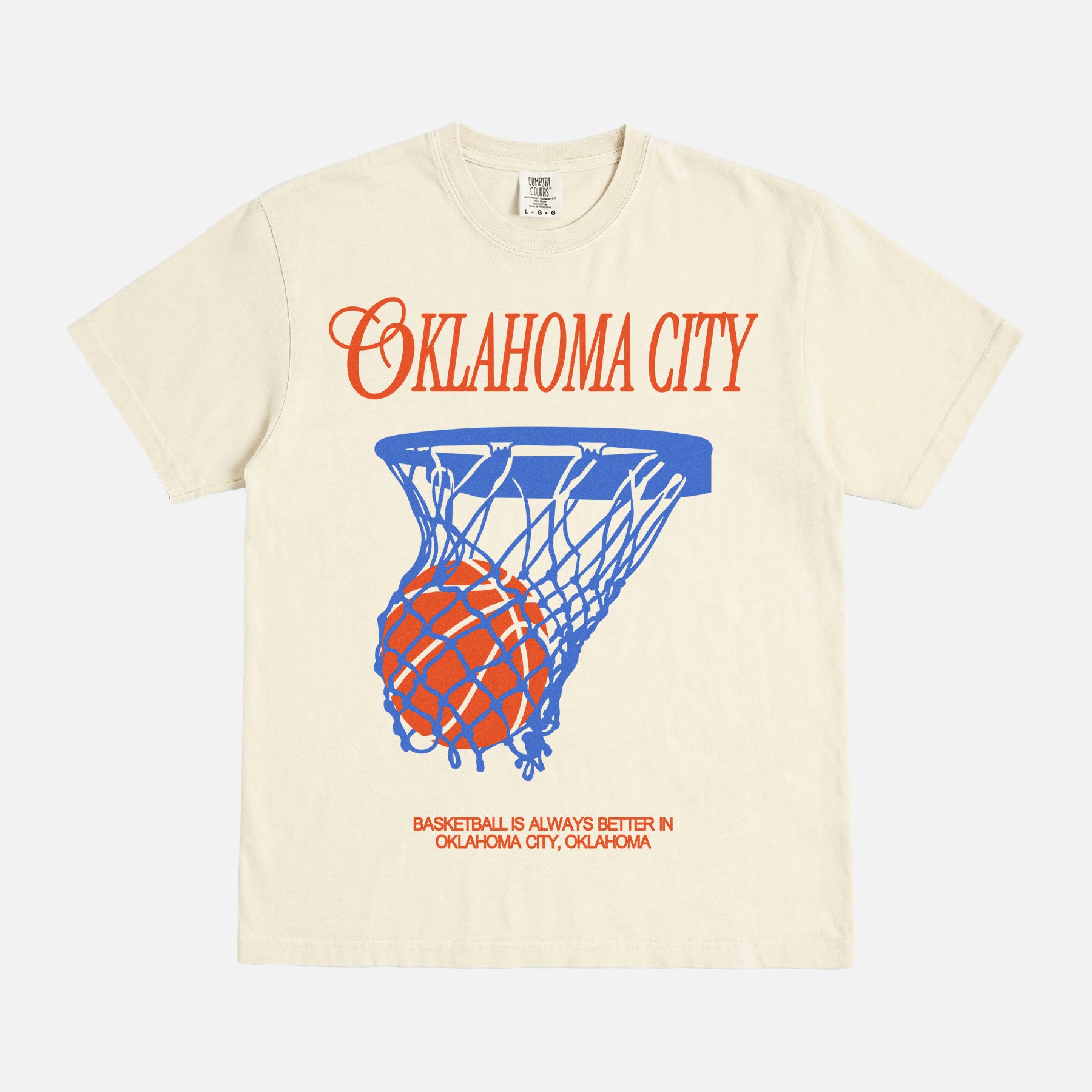 Vintage washed cream off white Oklahoma City basketball t-shirt with royal blue and orange OKC thunder bball graphic on a unisex Comfort Colors tee