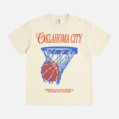 Vintage washed cream off white Oklahoma City basketball t-shirt with royal blue and orange OKC thunder bball graphic on a unisex Comfort Colors tee