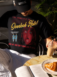 Person wearing Black The Shining movie t-shirt with 'Overlook Hotel' graphic - movie memorabilia for sale online at throwbacks
