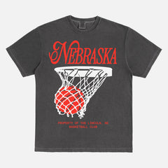 Retro Nebraska Cornhuskers t-shirt with retro college basketball streetwear graphic on a washed black comfort colors tee