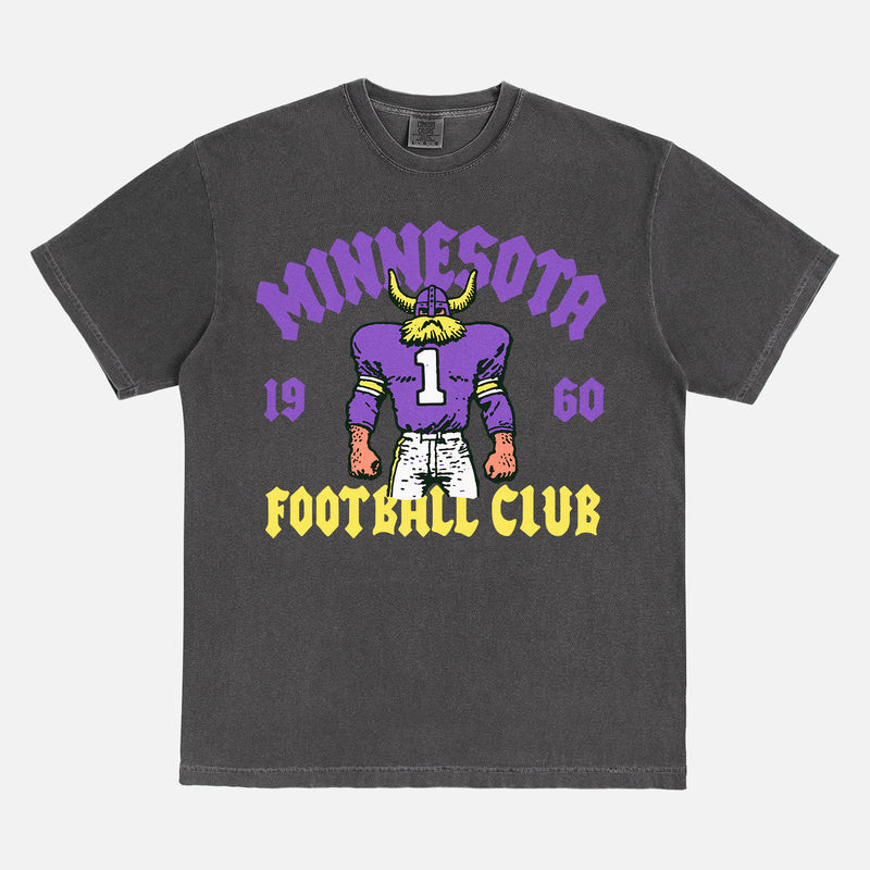 Minnesota Vikings NFL football fan streetwear graphic t-shirt with throwback viking mascot on a faded black comfort colors shirt