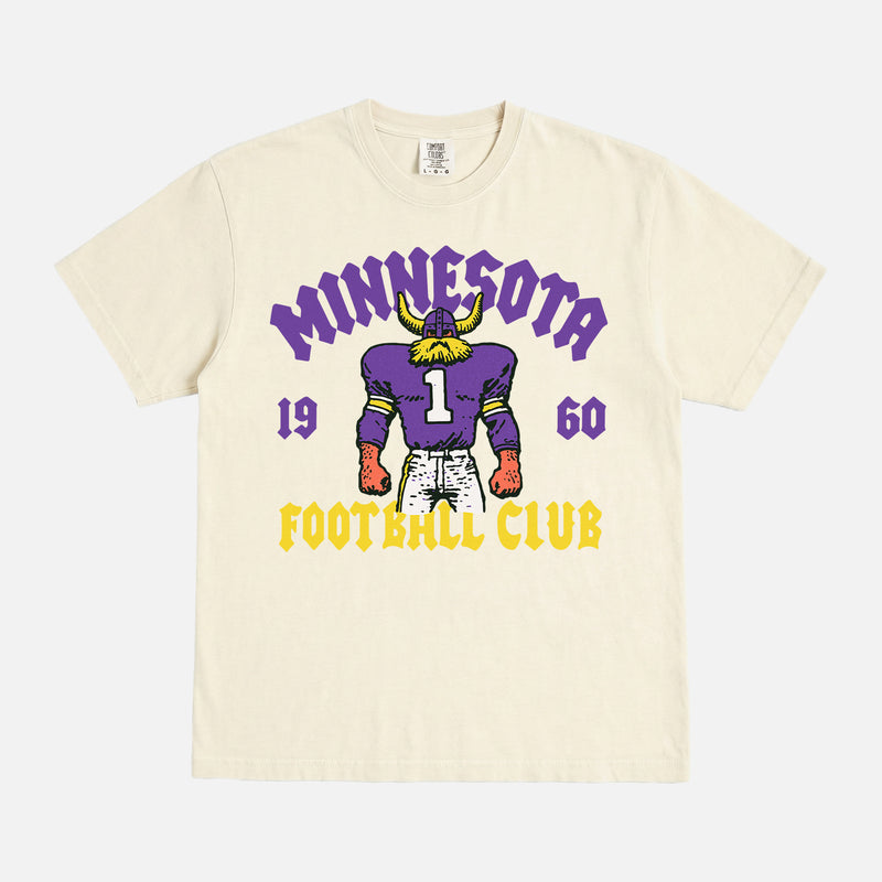 Minnesota Vikings NFL football fan streetwear graphic t-shirt with throwback viking mascot on a faded cream comfort colors shirt