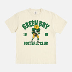 Modern vintage Green Bay Packers t-shirt with vintage mascot streetwear style graphic on a washed cream comfort  colors shirt
