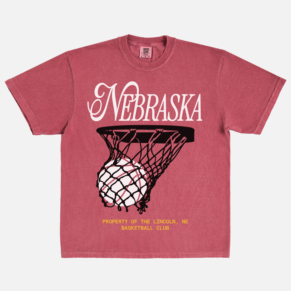Retro Nebraska Cornhuskers t-shirt with retro college basketball streetwear graphic on a washed red comfort colors tee