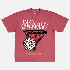 Retro Nebraska Cornhuskers t-shirt with retro college basketball streetwear graphic on a washed red comfort colors tee